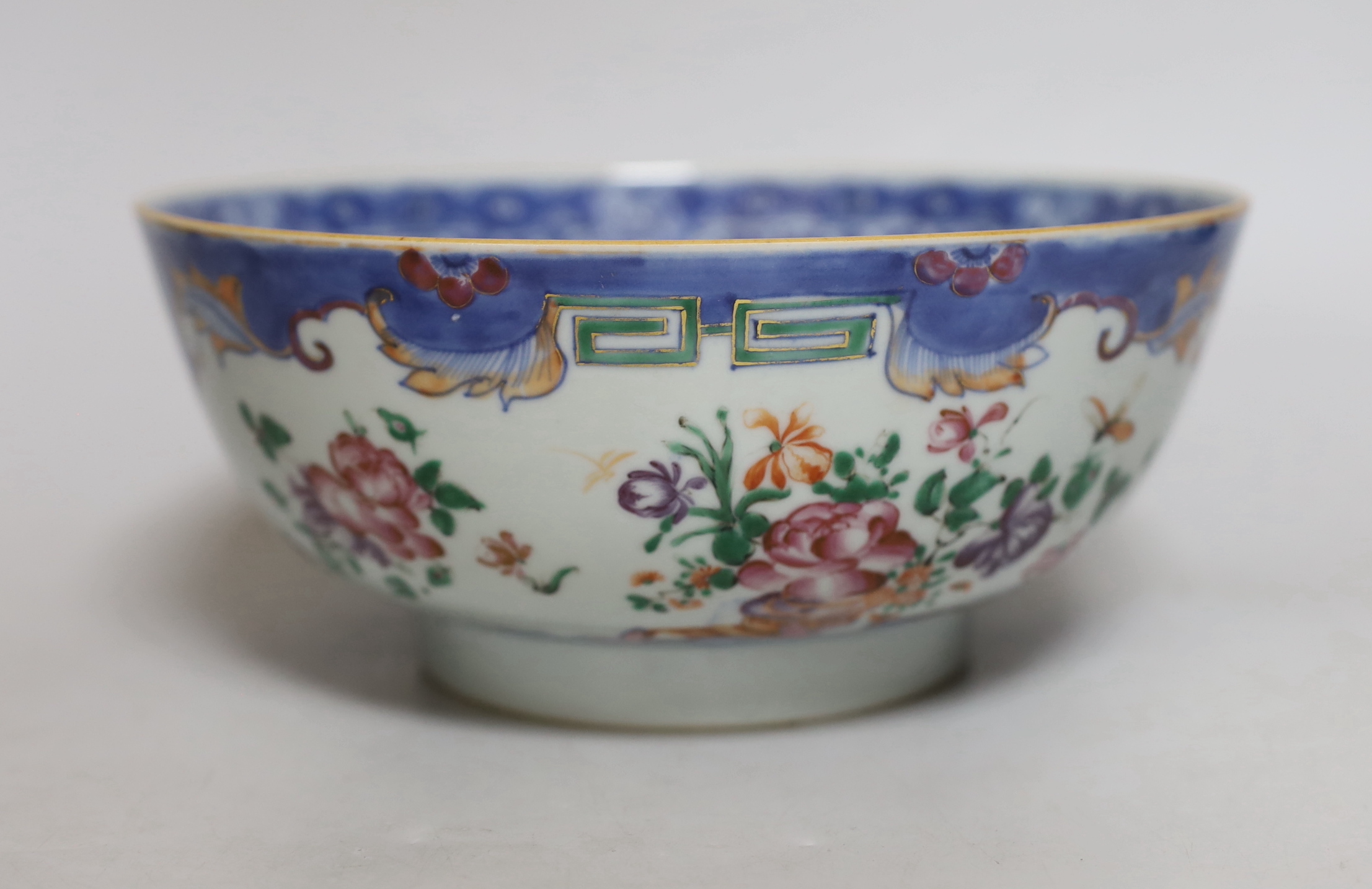 A Chinese famille rose bowl, Qianlong period, painted with insects amongst flowers, 23cm in diameter